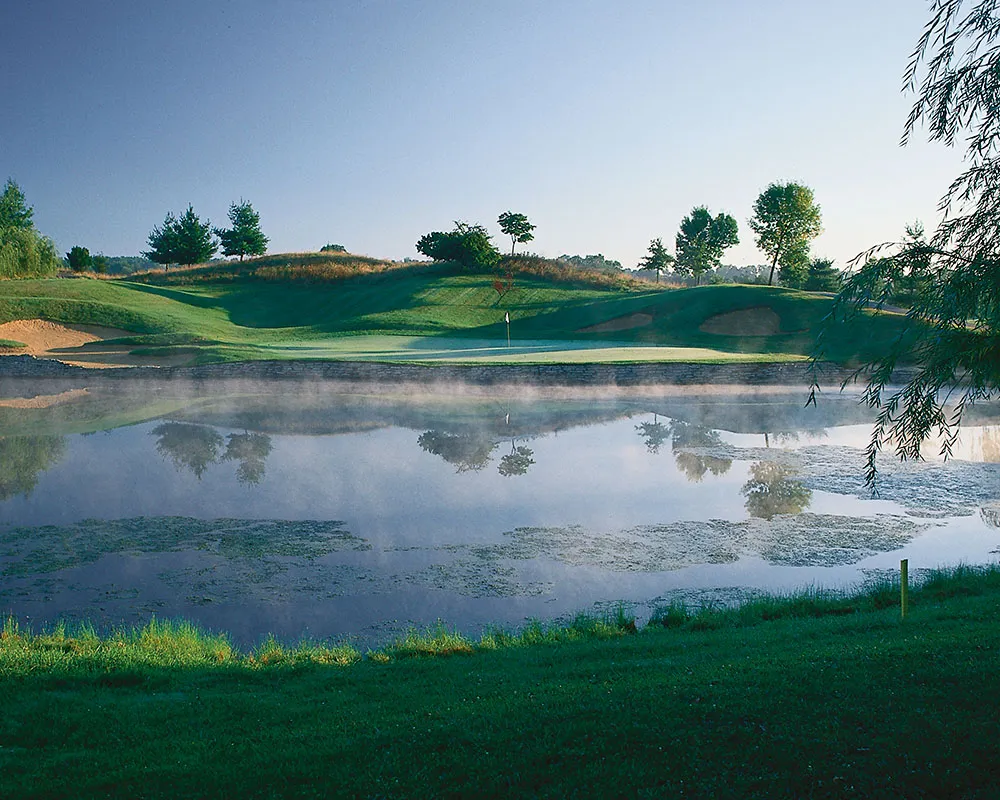 10th hole at EagleSticks looking over pond with rising mist